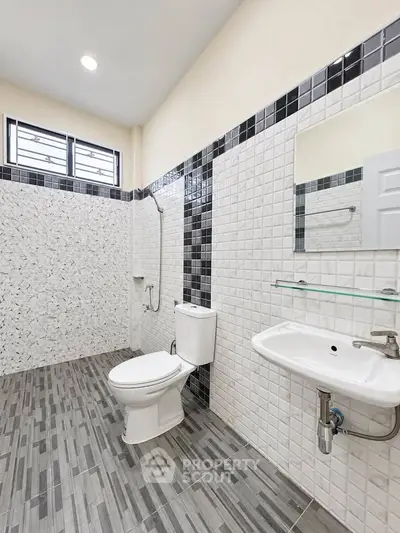 Modern bathroom with sleek tile design and contemporary fixtures.