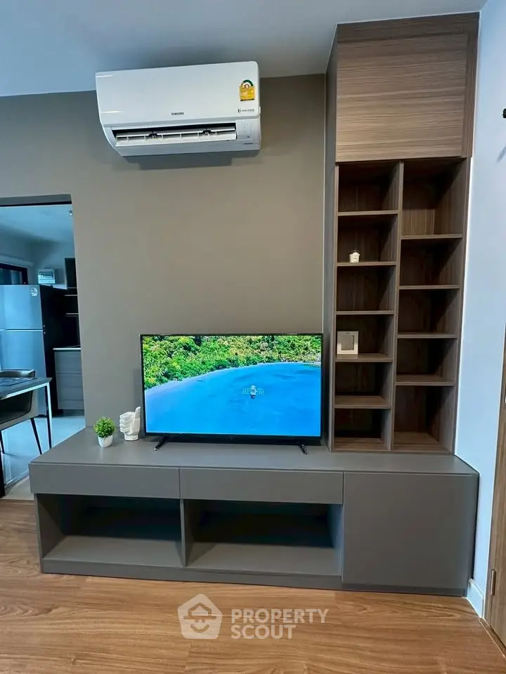 Modern living room with sleek TV unit and air conditioning, perfect for comfortable living.