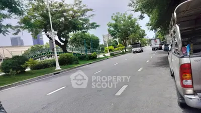 Scenic urban street view with lush greenery and modern buildings