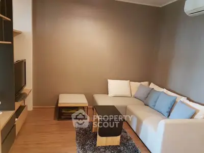Cozy living room with modern furniture and neutral tones, perfect for relaxation.