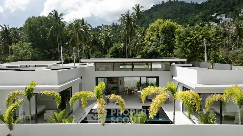 Luxurious modern villa with private pool and lush tropical surroundings, perfect for serene living.