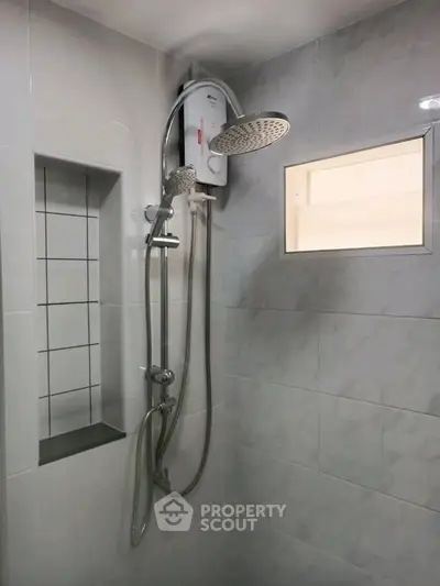 Modern bathroom shower with sleek design and built-in shelf