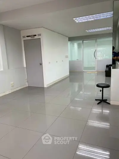 Spacious modern office space with sleek tile flooring and natural light