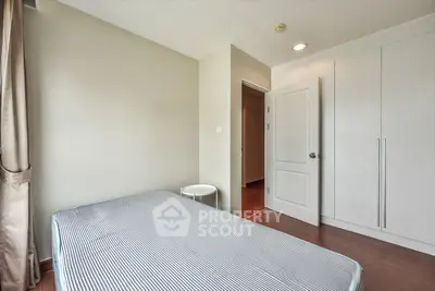 Cozy bedroom with minimalist design and ample natural light