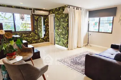 Stylish living room with modern decor and large windows offering city views.