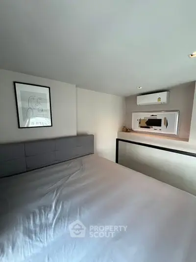 Modern bedroom with minimalist decor and air conditioning unit