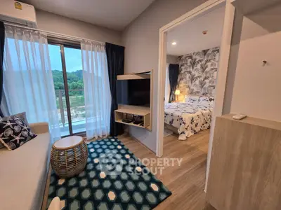 Chic modern apartment with cozy living room and stylish bedroom, featuring scenic views and elegant decor.