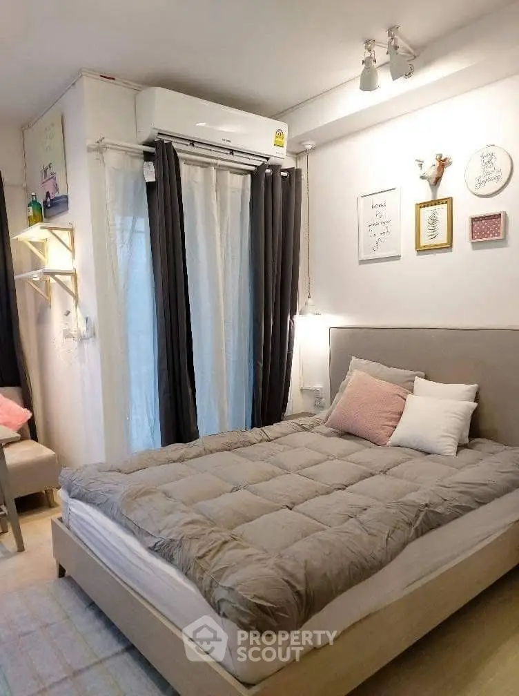 Cozy bedroom with modern decor and natural light, featuring a comfortable bed and stylish wall art.