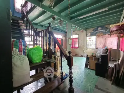 Charming rustic interior with wooden staircase and colorful decor in a cozy home setting.