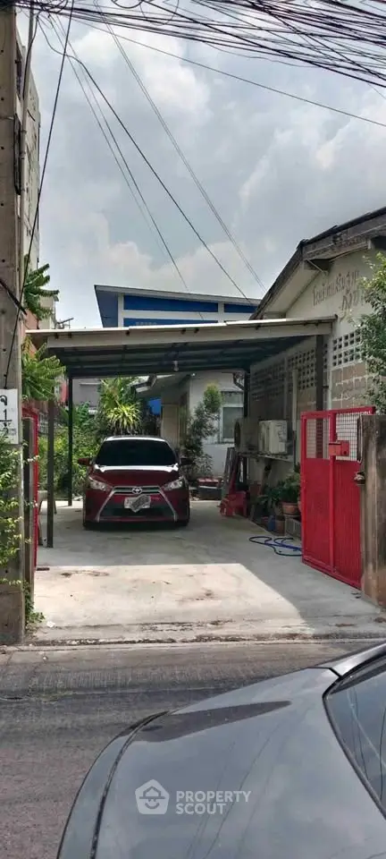 Charming residential property with covered parking and lush greenery in a serene neighborhood.