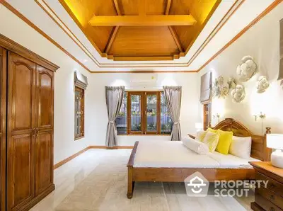 Luxurious bedroom with wooden ceiling and elegant decor