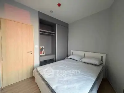 Modern minimalist bedroom with built-in closet and cozy bed in a stylish apartment.