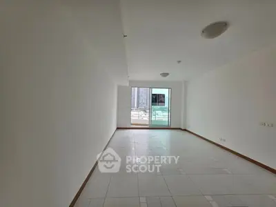 Spacious empty living room with balcony and city view, ideal for customization.