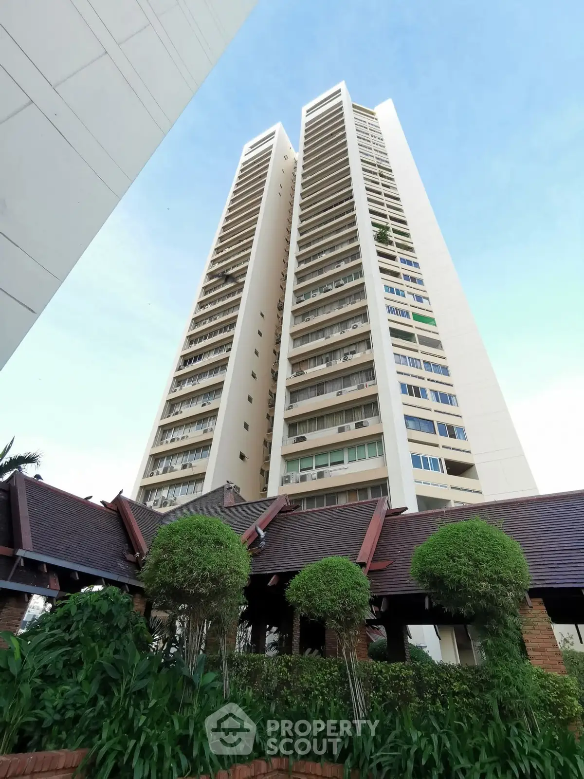 Stunning high-rise building with lush greenery and modern architecture