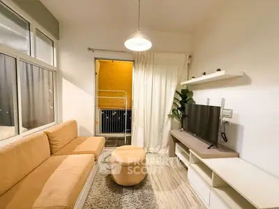 Cozy living room with modern decor and balcony access, featuring a plush sofa and stylish lighting.