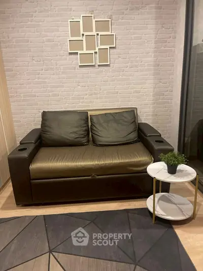 Modern living room with stylish sofa and geometric rug, perfect for cozy relaxation.