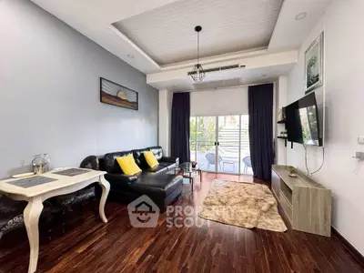 Stylish living room with modern decor and balcony access, featuring hardwood floors and elegant furnishings.