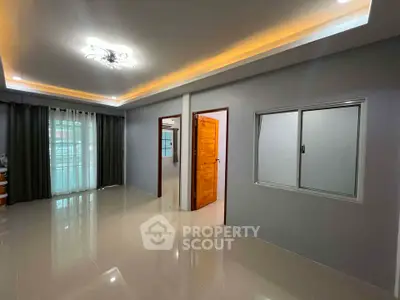 Spacious modern living room with sleek lighting and glossy tiled floors