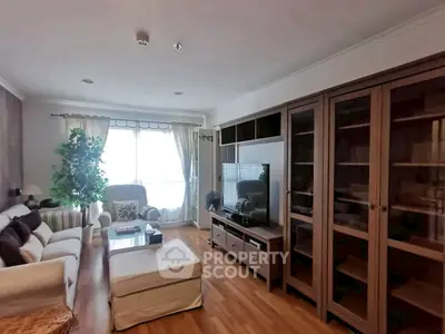 Spacious living room with elegant furniture and large windows for natural light.