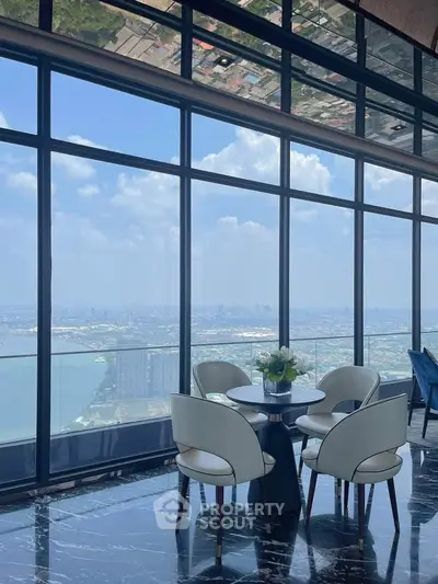 Luxurious high-rise apartment with stunning panoramic city and river views, featuring elegant modern furniture.