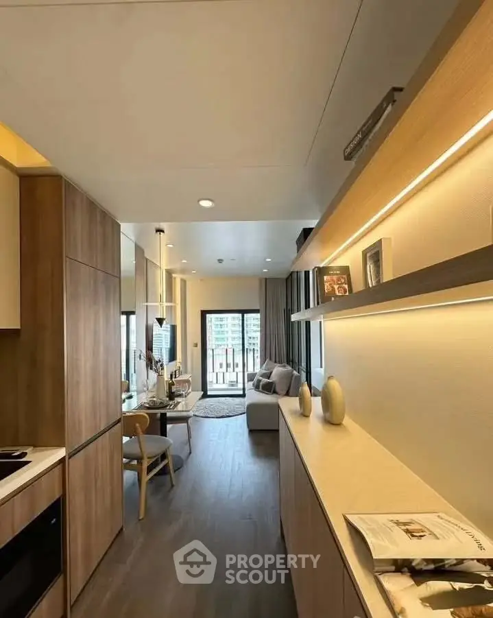 Modern open-plan living room with stylish decor and city view, featuring sleek wooden cabinetry and contemporary furniture.