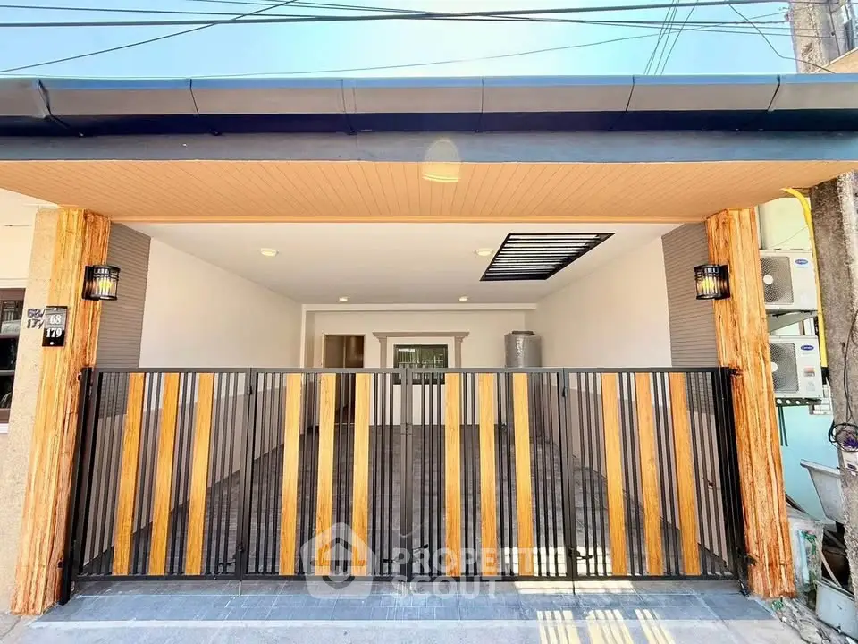 Modern house exterior with stylish gate and wooden accents, showcasing contemporary design and curb appeal.