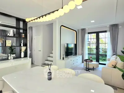 Modern living room with elegant decor and large windows overlooking garden