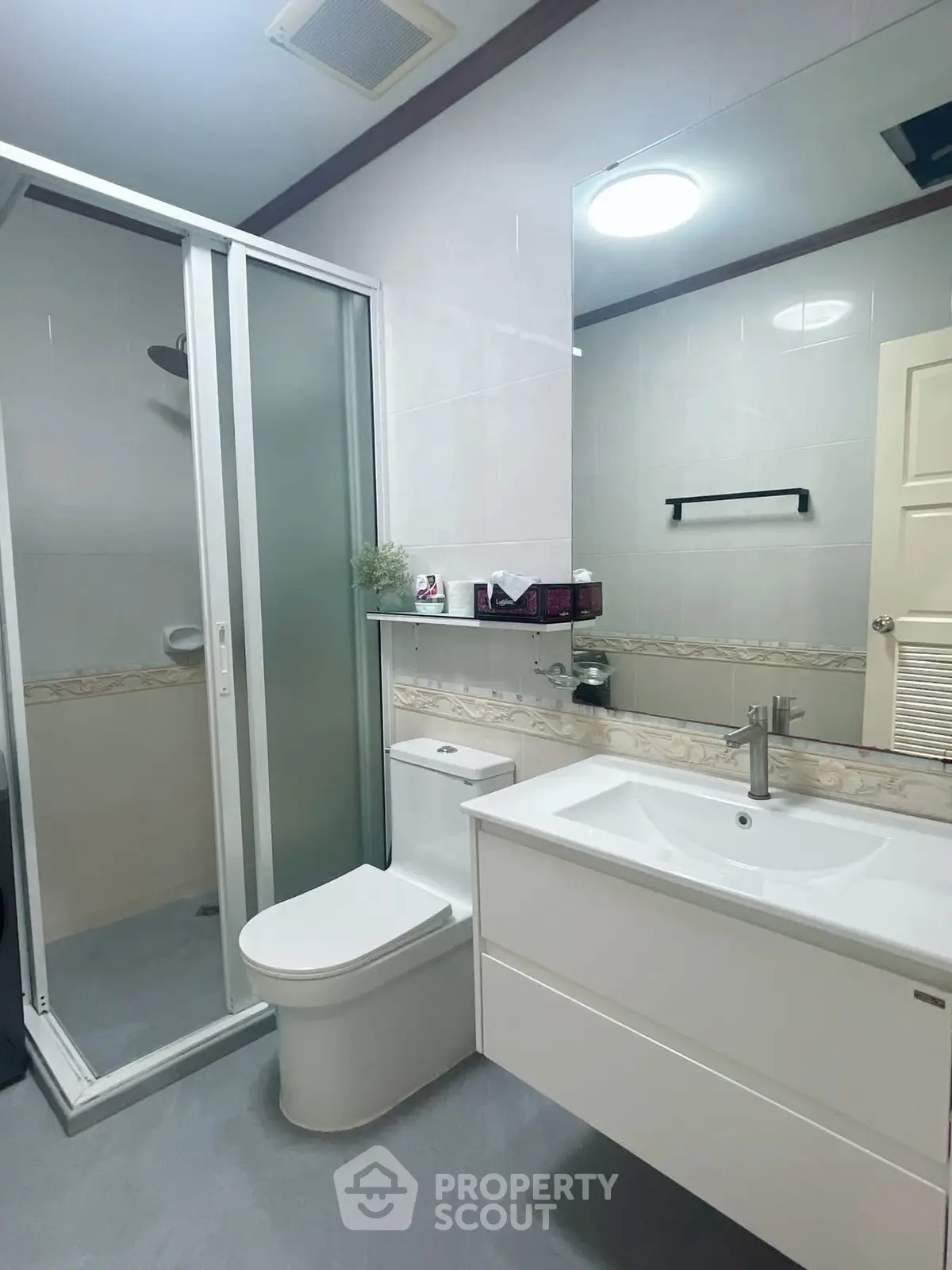 Modern bathroom with sleek fixtures and glass shower enclosure