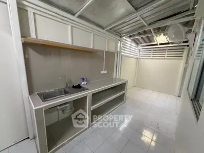 Spacious kitchen with open layout and modern fixtures in a well-lit area.