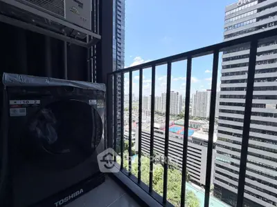 High-rise balcony with stunning cityscape view and modern washing machine.