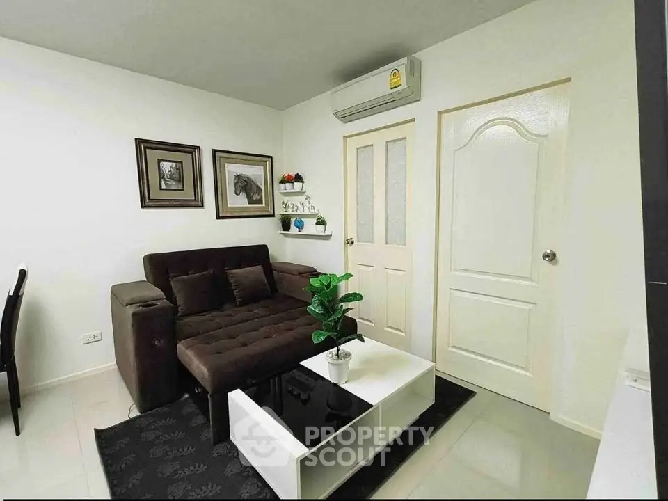 Cozy living room with modern decor and air conditioning in a stylish apartment.