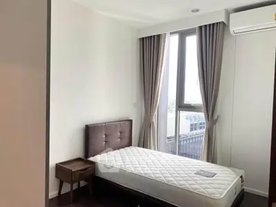 Modern bedroom with large window and air conditioning in a stylish apartment.