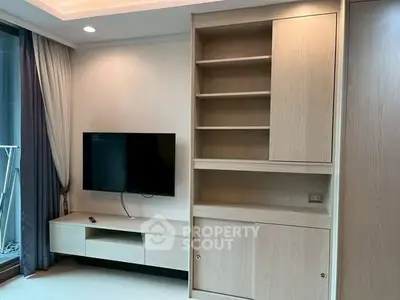 Modern living room with sleek TV unit and built-in shelving, perfect for stylish urban living.