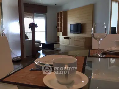 Modern living room with stylish wooden paneling and elegant dining setup