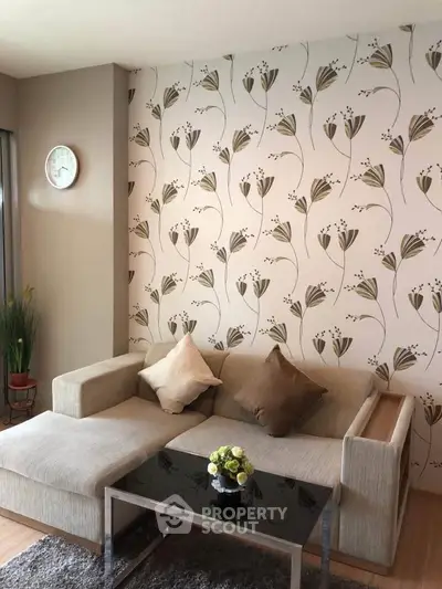 Chic living room with floral wallpaper and modern sofa, perfect for cozy relaxation.