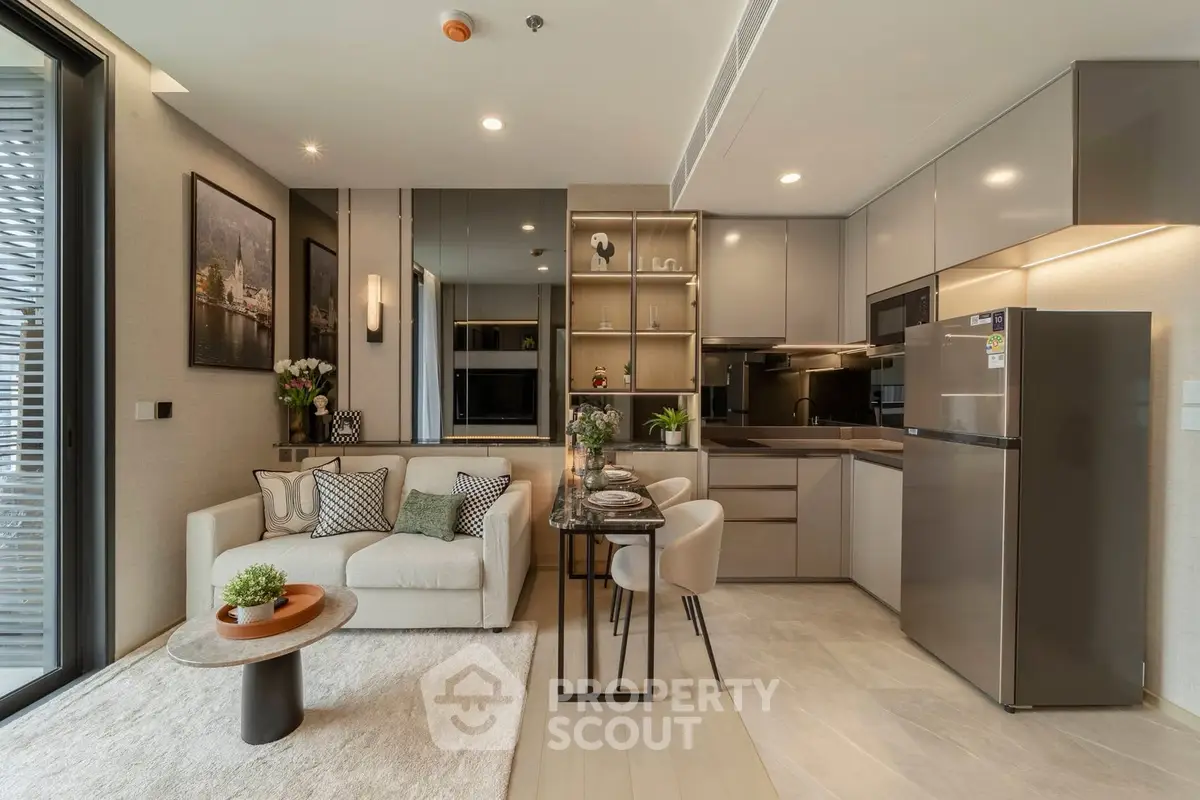 Modern open-layout living room and kitchen with sleek design and cozy ambiance.