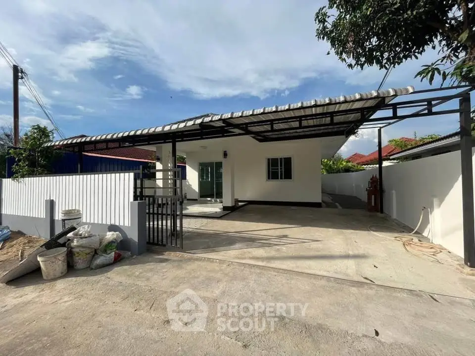 Charming single-story home with spacious driveway and modern exterior design.