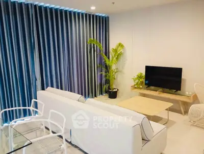 Modern living room with sleek furniture and large windows, perfect for relaxation and entertainment.