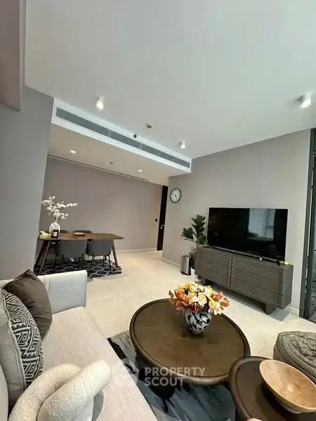 Modern living room with stylish decor and open layout, featuring a cozy seating area and elegant dining space.