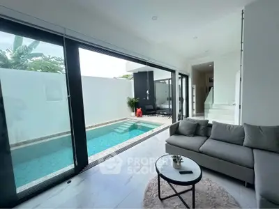 Modern living room with pool view and sleek interior design