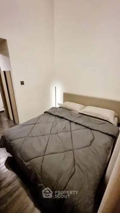 Cozy bedroom with modern decor and soft lighting, perfect for relaxation.