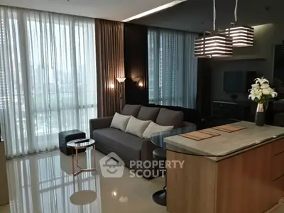 Modern living room with elegant decor and open kitchen layout