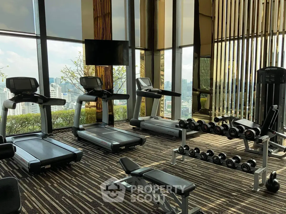 Luxurious high-rise gym with panoramic city views and modern equipment.