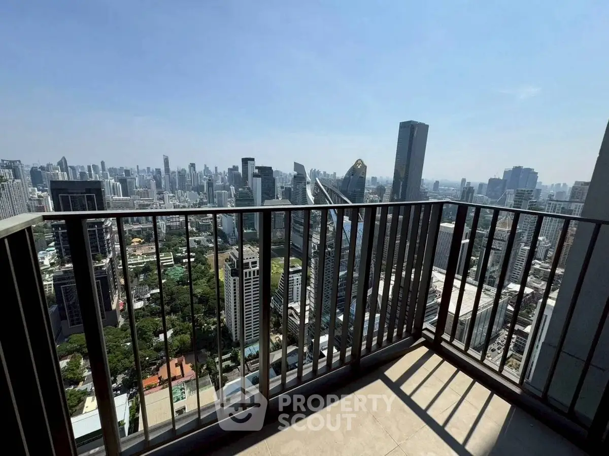 Stunning cityscape view from a high-rise balcony with modern railing design.