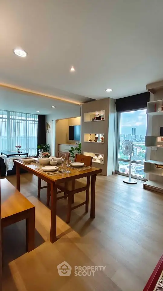 Spacious modern living room with dining area and city view