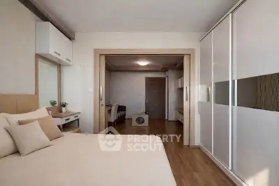 Spacious bedroom with modern decor and sliding wardrobe doors