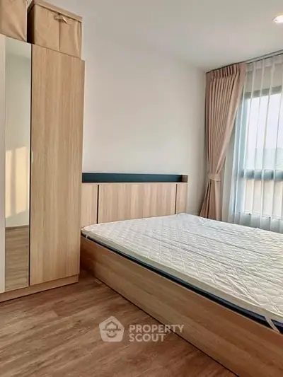 Modern bedroom with wooden furniture and natural light