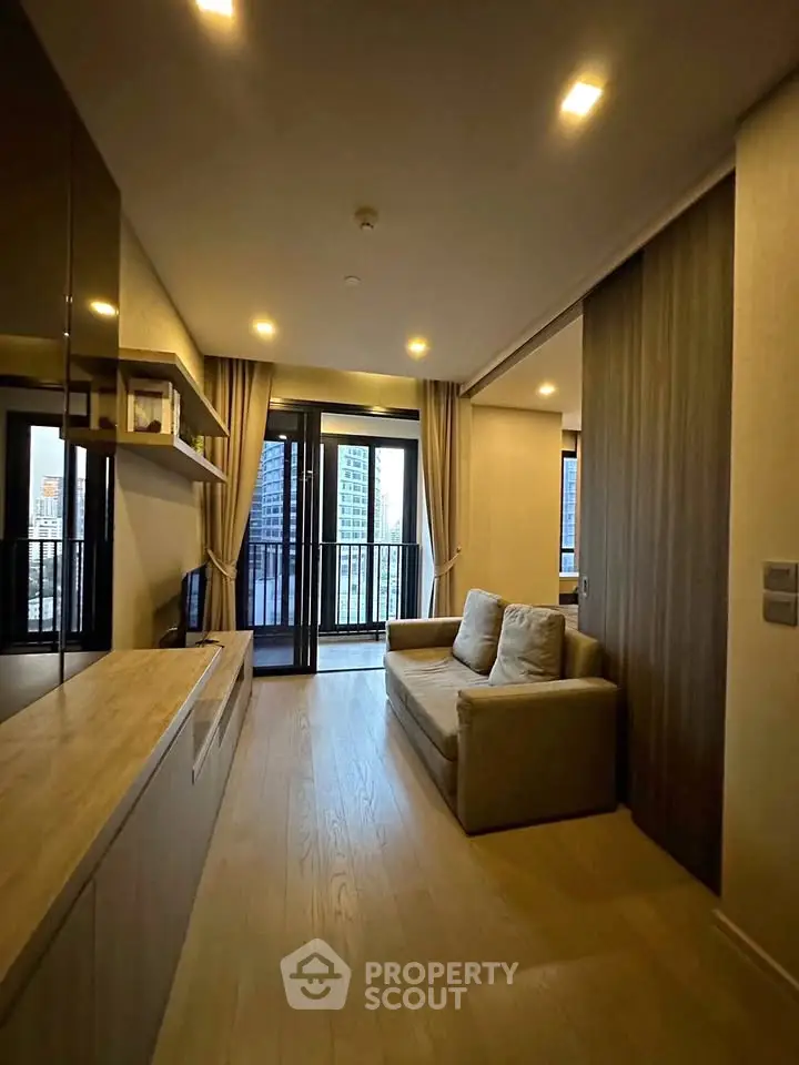 Modern living room with cozy sofa and city view balcony in high-rise apartment