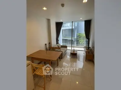 Modern living room with sleek furniture and large window for natural light
