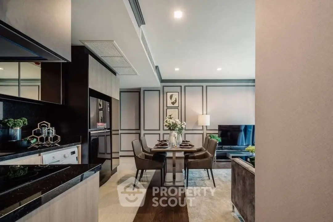 Modern open-plan living and dining area with sleek kitchen design and elegant decor.